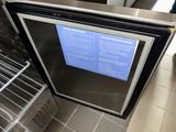 a black and silver refrigerator with a blue sign on it