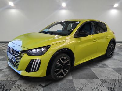 a bright yellow car is parked in a room with a checkered floor