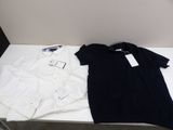 a white shirt and a black shirt sitting on a table