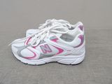 a close up of a pair of white and pink shoes