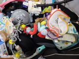 a baby stroller filled with baby items and toys