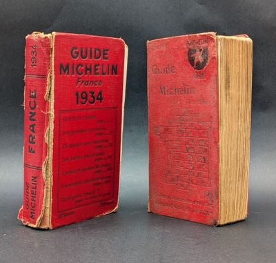 two red books sitting on top of each other on a table
