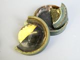 a small metal container with a piece of paper inside of it