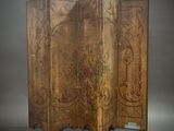 an old wooden screen with floral designs on it on a gray background