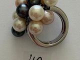 a ring with a bunch of different colored pearls on it