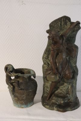 a statue of a man and a vase on a table