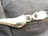 a close up of a zipper on a black bag