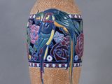 un grand vase orné d'un oiseau, posé sur une table