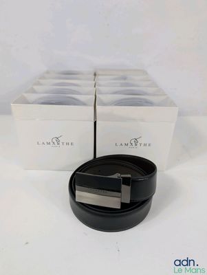 a close up of a black belt on a white surface