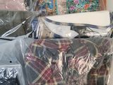 many bags of clothes sitting on top of each other