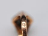 a close up of a gold ring with a diamond