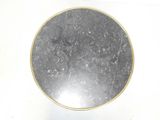 a picture of a black and gold plate on a white surface
