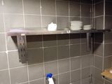 a shelf with dishes on it in a kitchen