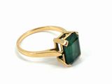 a gold ring with a green tourmaline stone in it
