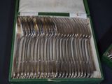 a lot of silverware in a box on a table