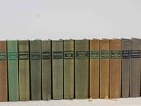 several books are lined up in a row on a white surface