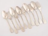 six silver spoons and a fork on a white surface
