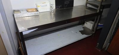 a metal table with a chalk board on top of it