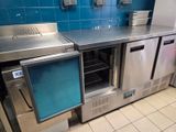 a stainless steel counter top with a refrigerator and freezer