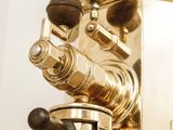 a close up view of a brass plated coffee machine