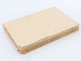 a stack of brown paper sitting on top of a white table