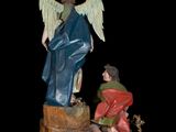 figurine of a statue of an angel and a boy kneeling on a rock
