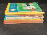 several children ' s books stacked on top of each other on a table