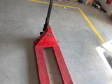 a fork lifter sitting on the floor in a garage
