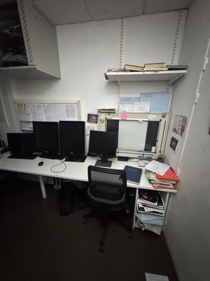 a desk with two monitors and a computer on it