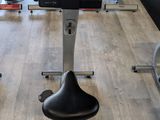 a wooden table with a row of stationary exercise bikes on it
