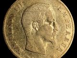 a close up of a gold coin with a man ' s face on it