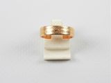 a close up of a gold ring on a white surface