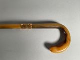 a close up of an umbrella with a wooden handle