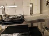 a metal shelf that has a bunch of trays on top of it