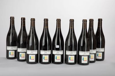six bottles of wine lined up in a row on a table
