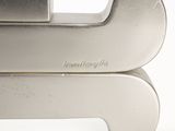 a close up of a metal object on a white surface