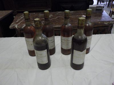 several bottles of wine are lined up on a table