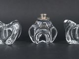 three glass vases sitting on top of a table next to each other