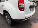 a white car that is parked on the side of the road