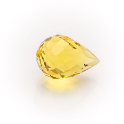 a close up of a yellow diamond on a white background