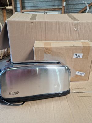 a toaster sitting on a table next to a box