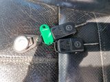 two keys attached to the seat belt of a car