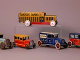 five toy cars that are lined up in a row
