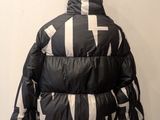 the back of a black and white jacket on a mannequin mannequin