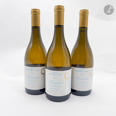 trois bouteilles de vin posées sur une table blanche