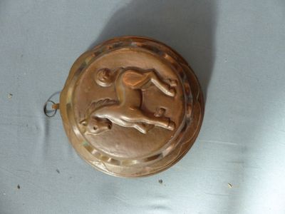 a metal object with a horse on it on a table