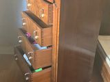 a wooden dresser with drawers in a room