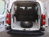 a white van with a tire in the back of it