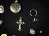 a collection of antique and modern jewelry on a black background