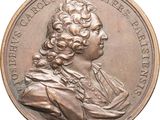 an image of a bronze medal with a portrait of a man